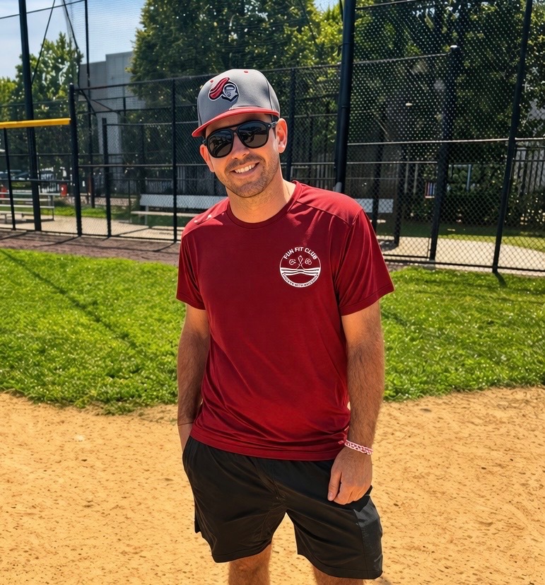 Coach Frank at the ballfield wearing a Fun Fit Club shirt